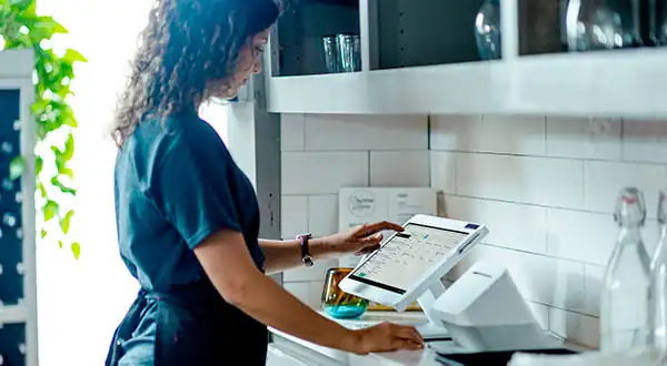 a woman using a Clover POS